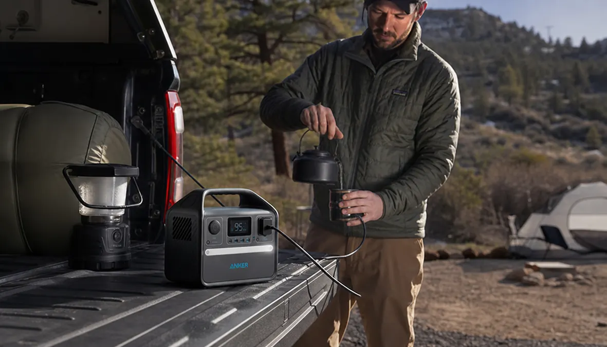 Anker 521 power station sitting on a truck tailgate with camping gear loaded around it